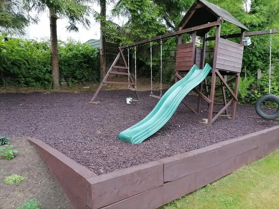 The same play area edged with sleepers and finished in dark chippings