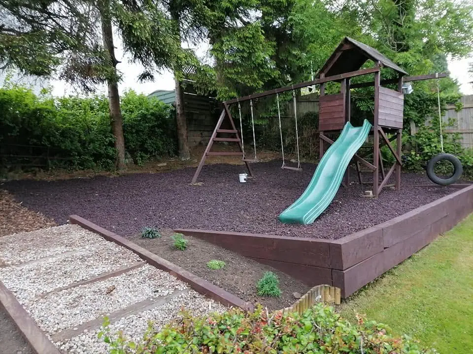 The play area finished with a climbing frame, sleeper edging, dark chippings and a gravel path