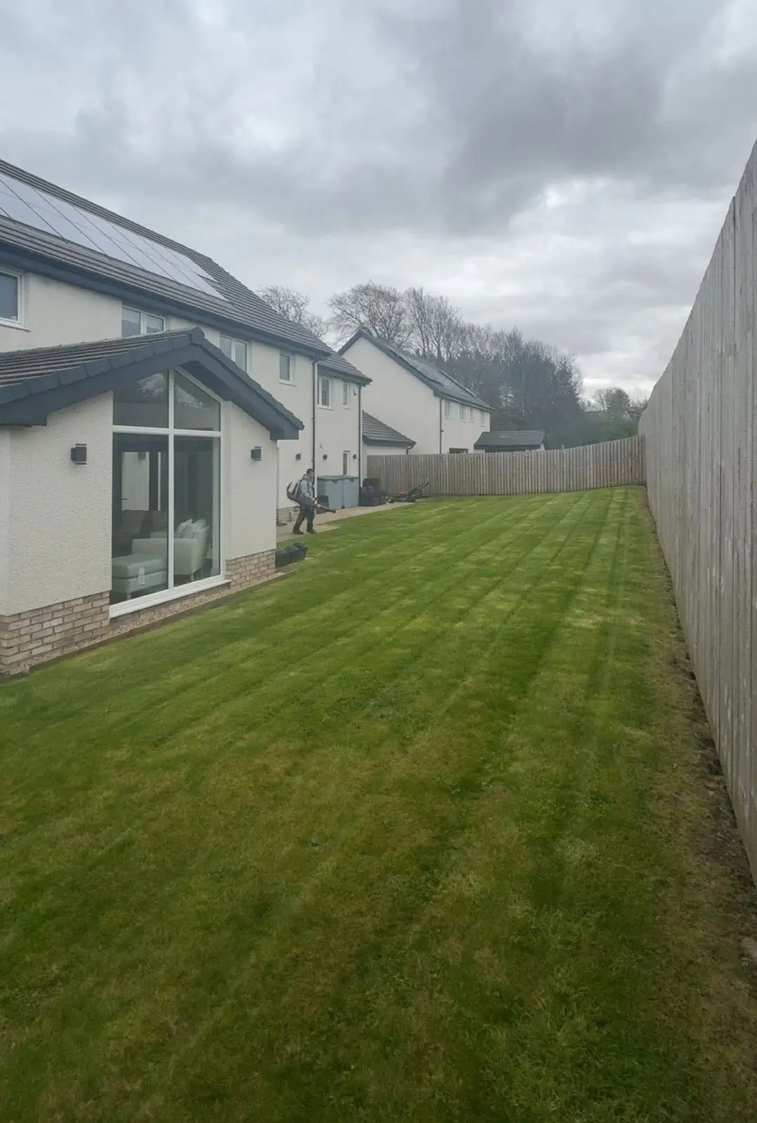 The same lawn from the other end, the mower in the distance